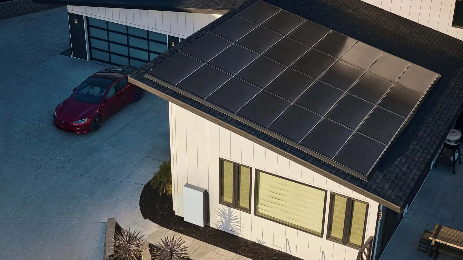 Desert home with a Tesla Solar Roof and a car